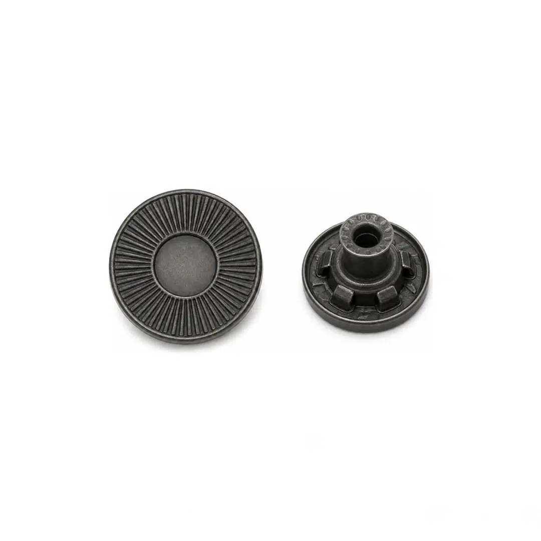 Matte black sunburst jeans button shown from the front and back